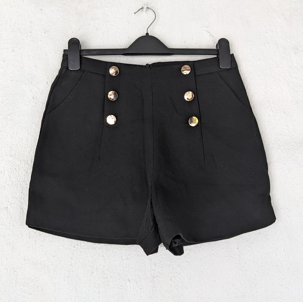 Black shorts with gold buttons